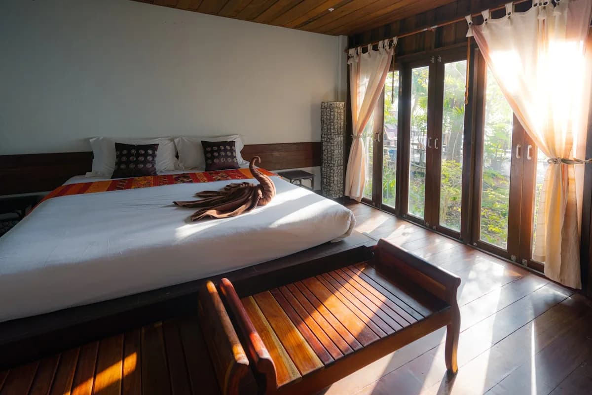 A sunlit, gold-accented suite interior at Ora Grands